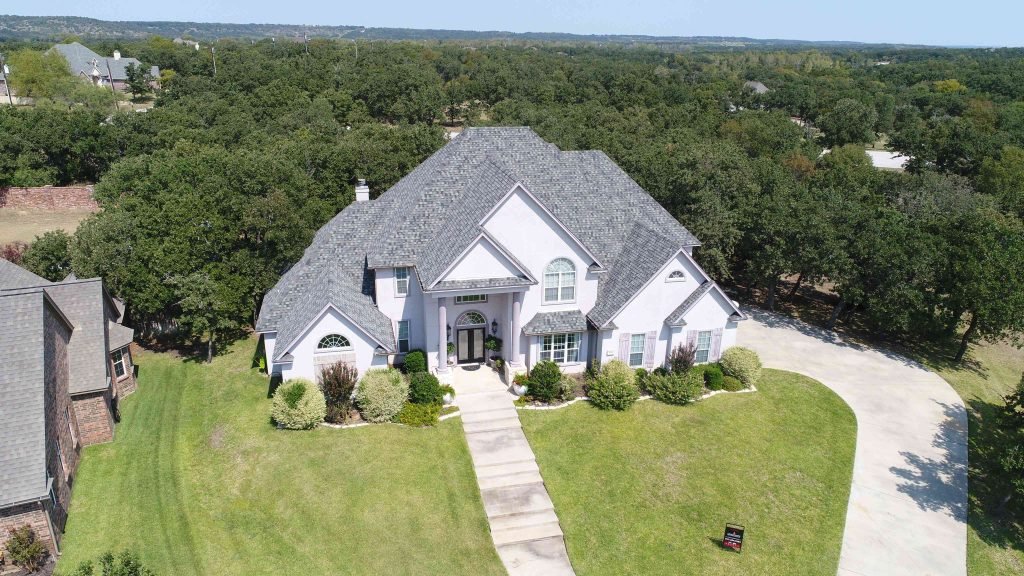 Large home with asphalt shingle roof.